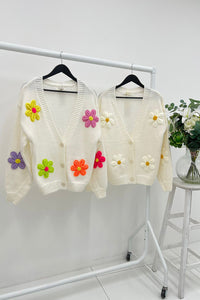 Cardigan – Cozy knit, playful floral details.