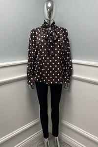 Polka dot bow blouse — silky shine with a bold necktie.