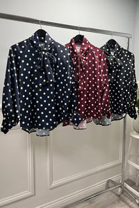 Polka dot bow blouse — silky shine with a bold necktie.
