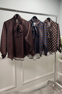 Polka dot bow blouse — silky shine with a bold necktie.