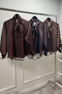Polka dot bow blouse — silky shine with a bold necktie.
