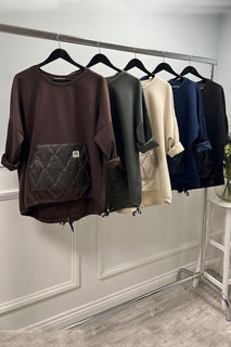 Navy quilt pocket sweatshirt — sporty-chic comfort with a bold textured front detail.