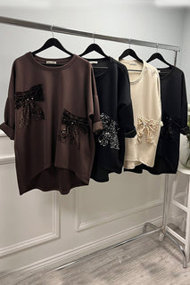 Chocolate bow top — oversized elegance with velvet sequin bows for a luxe statement.