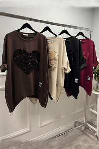 Sequin heart tunic — oversized comfort meets bold sparkle with a zip accent twist.