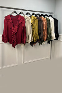 Ruffle Front Blouse features cascading ruffles along the deep V-neckline and sleeve cuffs.&nbsp;