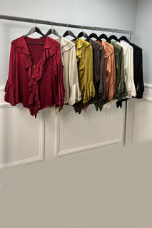 Ruffle Front Blouse features cascading ruffles along the deep V-neckline and sleeve cuffs. 
