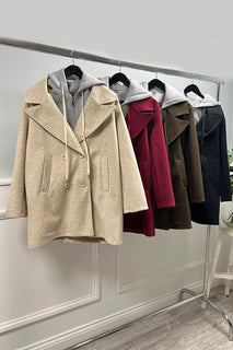 double-breasted coat layered with a hoodie