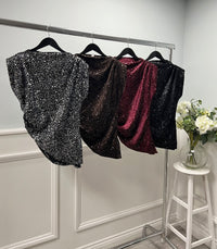 Sleeveless sequin top with padded shoulders and an asymmetric drape hem