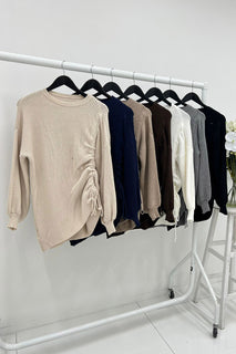 Long sleeves , Crew neck jumper with  asymmetrical hemline