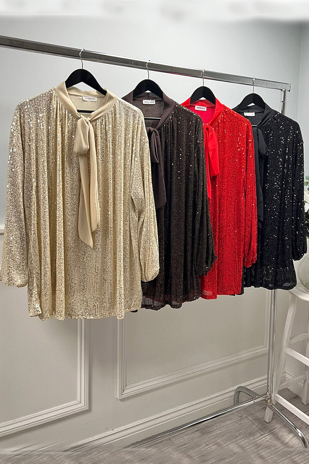 Sequin tunic blouse with a satin bow tie neckline and flowy fit