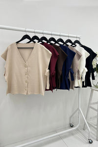 V-neck , sleeveless waistcoat with gold-toned buttons