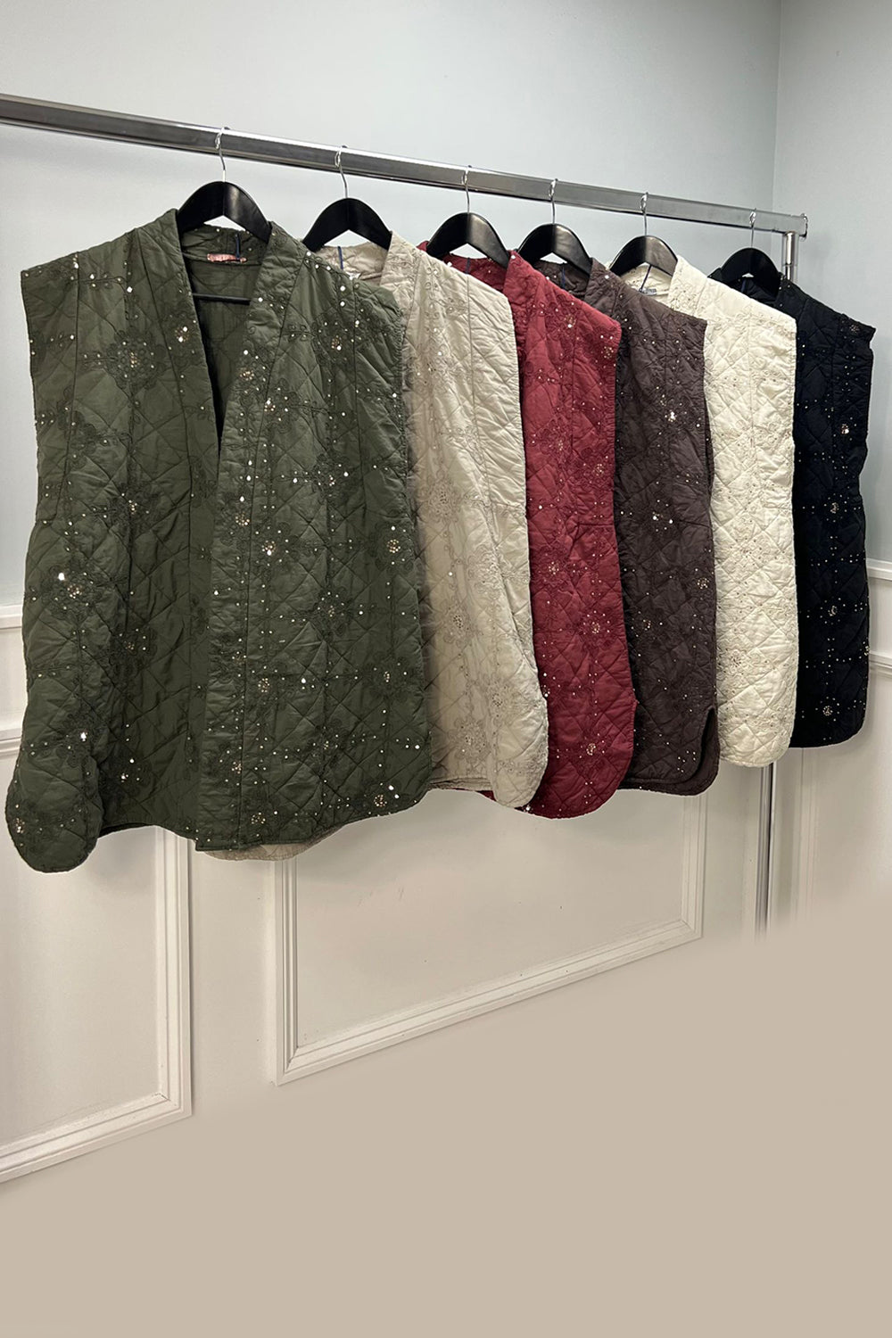 Quilted sleeveless jacket with delicate floral embroidery and sequin detailing