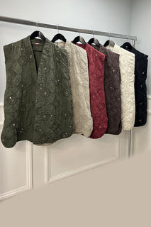 Quilted sleeveless jacket with delicate floral embroidery and sequin detailing