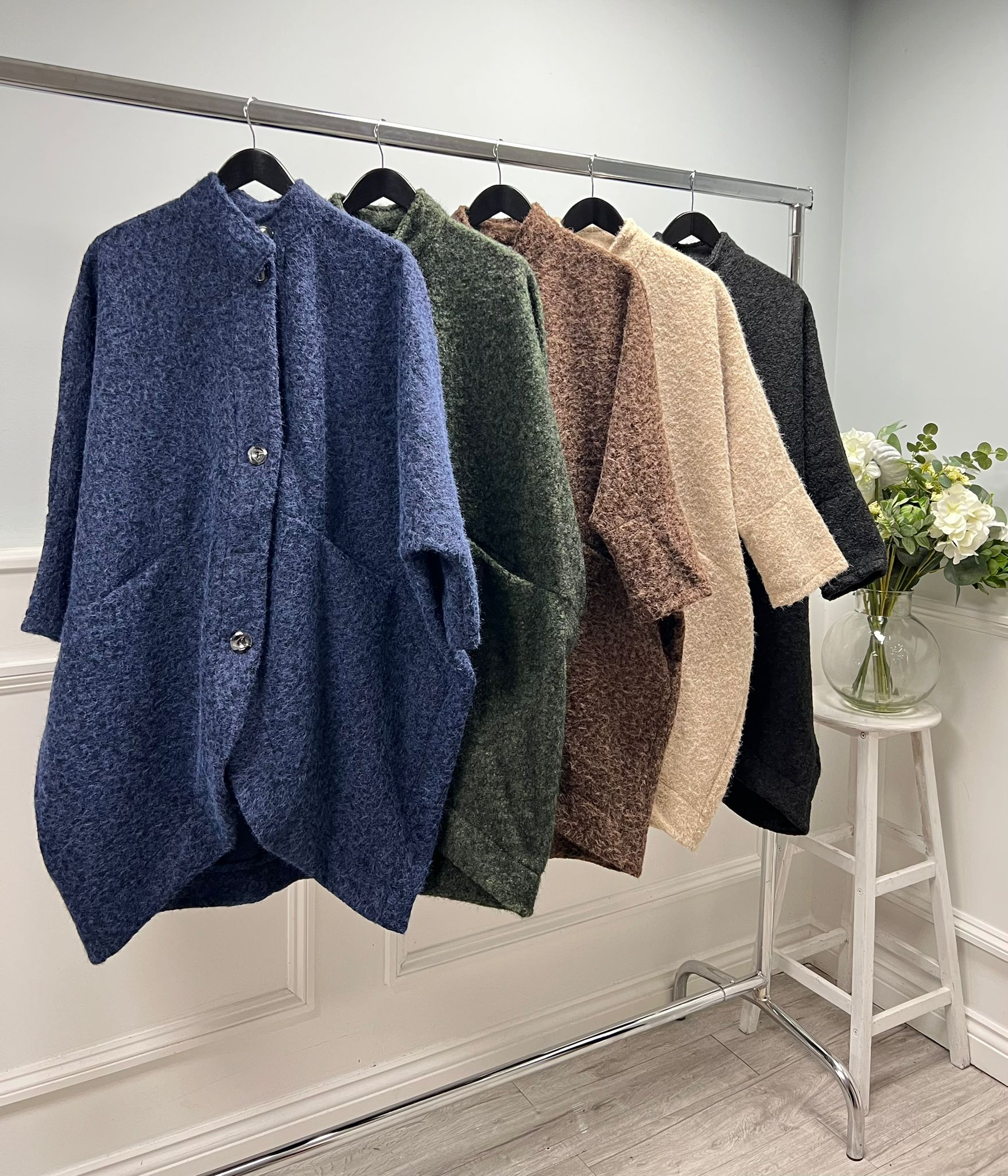 Soft wool coat with a stand collar, curved hem, and oversized buttons