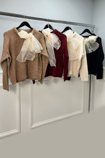 soft knit top with a charming organza bow at the neckline