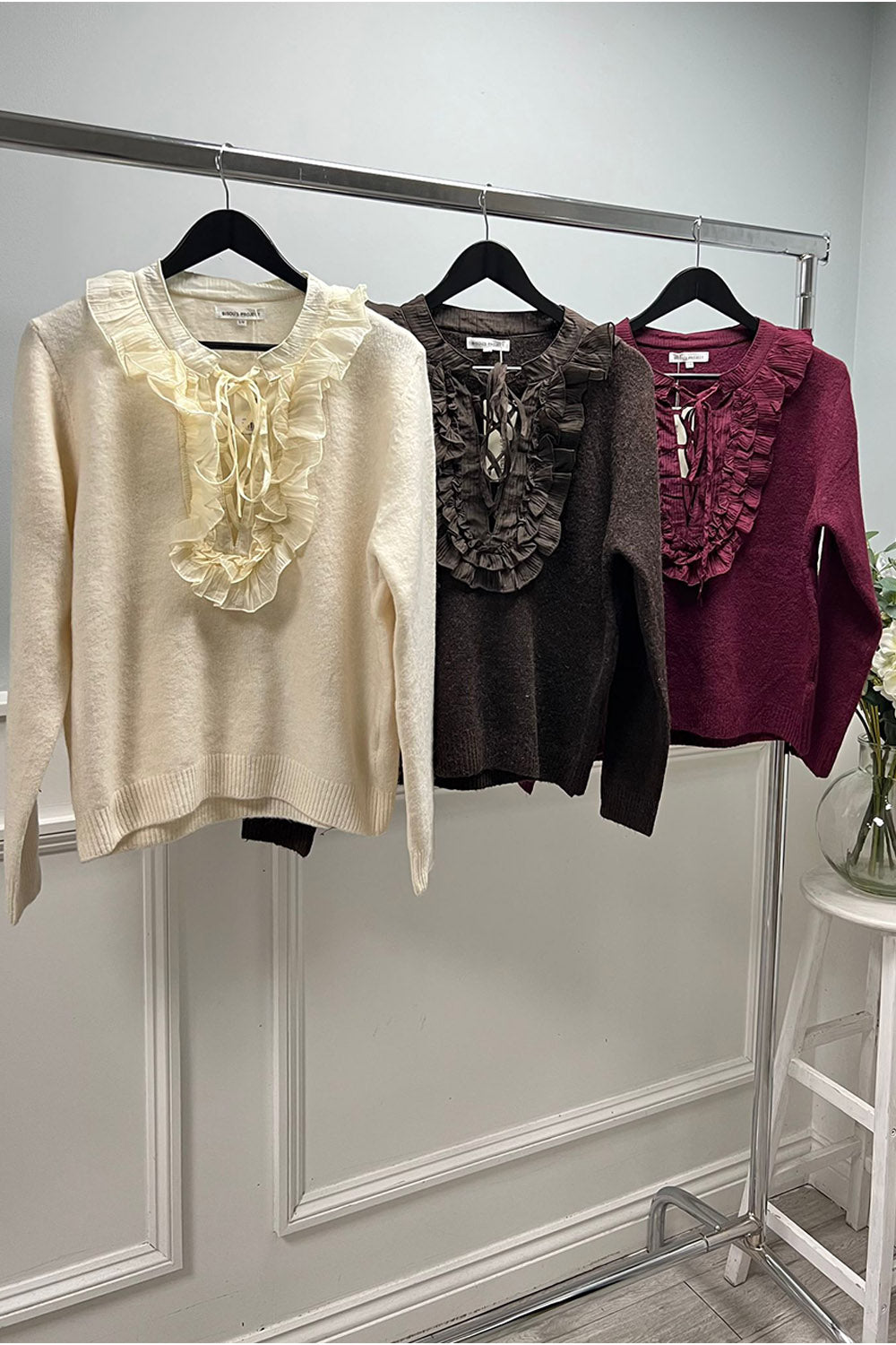 Ruffled knit sweater with lace-up neckline