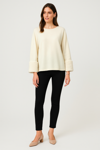 Cream luxe top — soft-touch fabric with plush faux fur cuffs for an elegant winter finish.