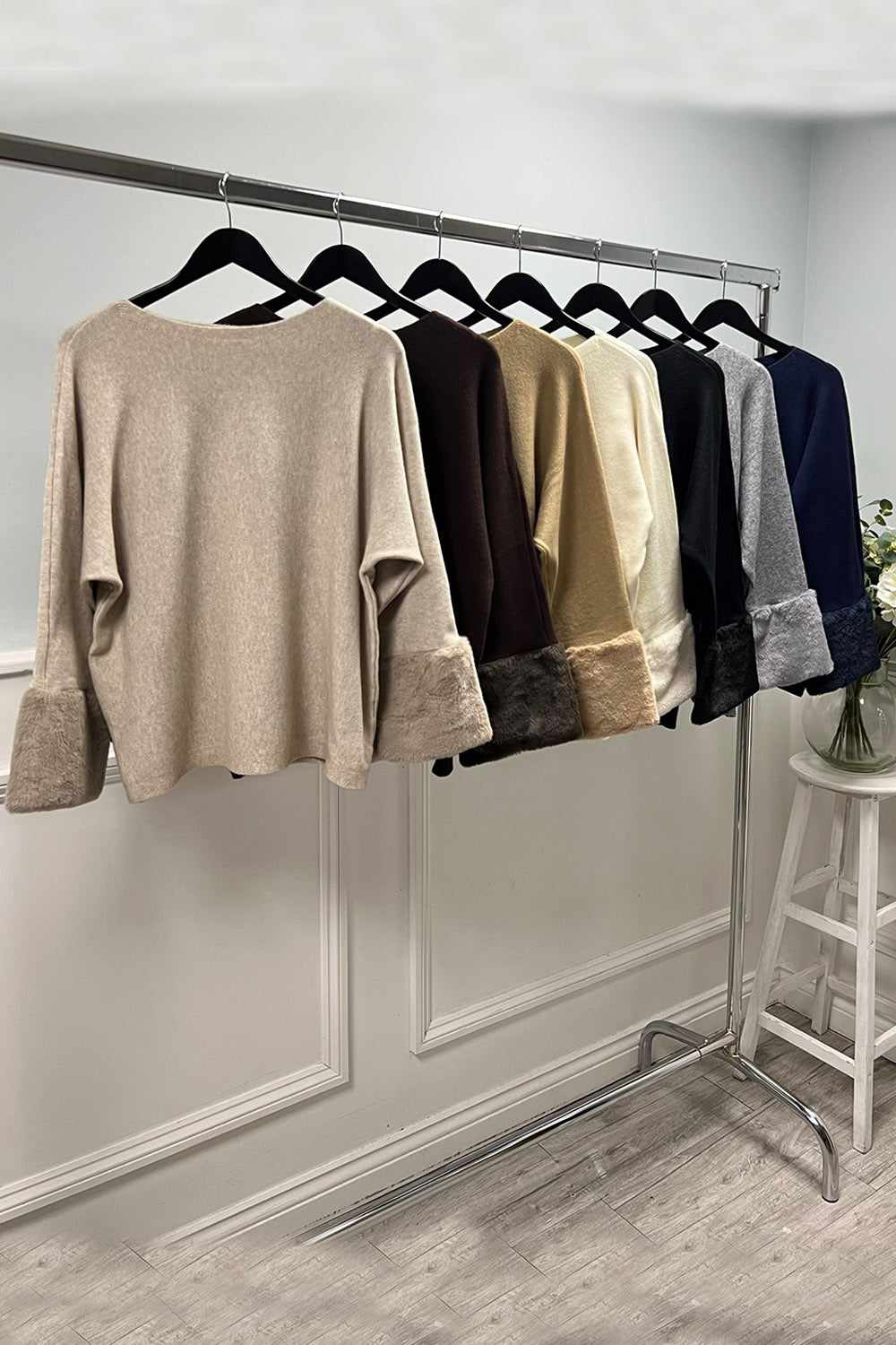 Cream luxe top — soft-touch fabric with plush faux fur cuffs for an elegant winter finish.