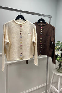 Cream cardigan with rainbow buttons