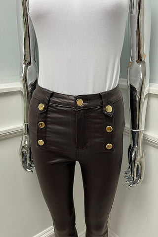 Modern polish — high-waist brown leather pants with bold gold buttons