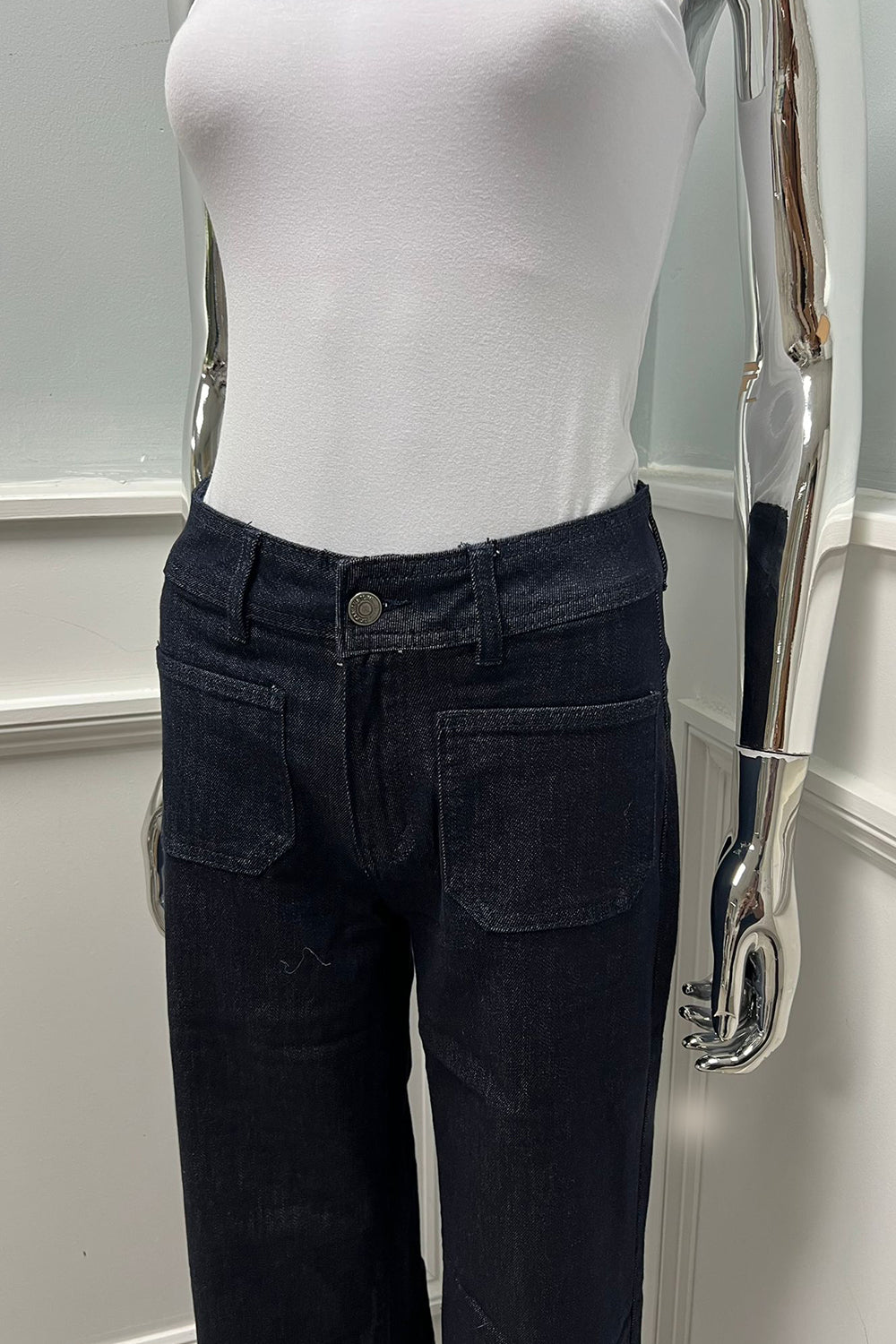 Refined minimalism — high-rise dark denim with front pockets and a sleek wide-leg silhouette