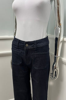 Refined minimalism — high-rise dark denim with front pockets and a sleek wide-leg silhouette
