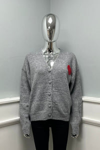 V-neck and button-down front cardigan with a red heart patch