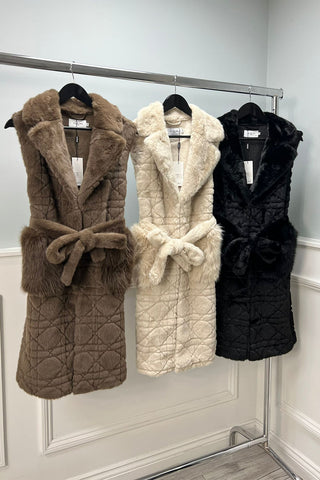 Quilted Faux Fur Belted Vest – Designed with a wide notched collar, self-tie belt.