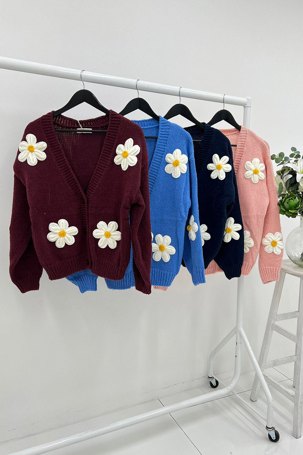 Cardigan – Cozy knit, playful floral details.