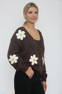 Cardigan – Cozy knit, playful floral details.