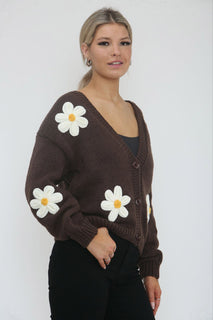Cardigan – Cozy knit, playful floral details.