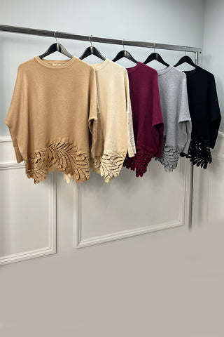 a relaxed fit jumper with a unique laser-cut leaf pattern along the hem