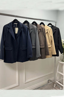 Blazer with structured shoulders and flap pockets — featuring a sleek two-button closure