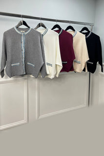 Chic cardigan with textured fabric, featuring blue braided trim and front pockets