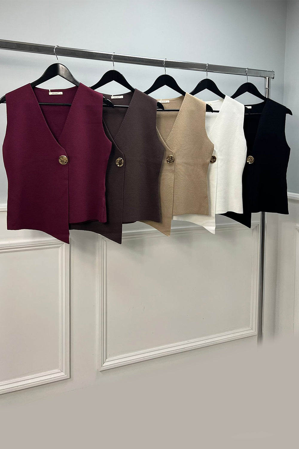 V neck sleeveless jacket with a chic gold button closure